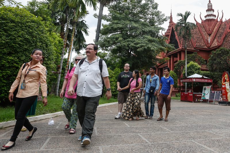 A private tour guide, left, leads a couple out of the National Museum in Phnom Penh on Tuesday. (Siv Channa/The Cambodia Daily)