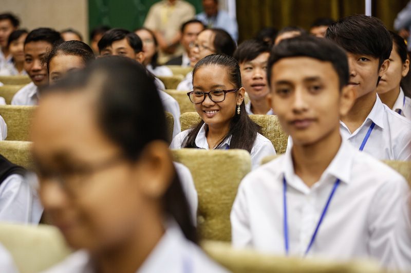 Students who received an A on the national high school exit exam listen to Prime Minister Hun Sen speak during an awards ceremony in Phnom Penh yesterday. (Siv Channa/The Cambodia Daily) 