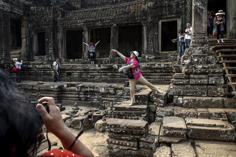 Tourists pose for a photograph at the Angkor Wat temple complex in Siem Reap province last year. (Reuters)