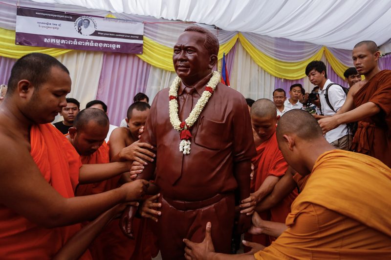 Monks move a statue of Kem Ley during his 100-day funeral ceremony at Phnom Penh's Wat Chas on Friday. (Siv Channa/The Cambodia Daily)