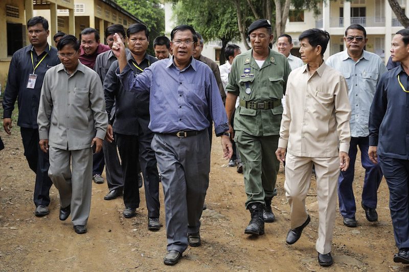 Prime Minister Hun Sen tours a school in Pailin province along with bodyguards and officials on Wednesday in a photograph posted to his Facebook page. 