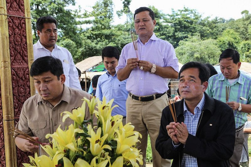 Environment Minister Say Sam Al, left, and timber magnate Try Pheap, center, offer incense at a shrine in Preah Vihear province, in a photograph posted to the Facebook page of Mr. Pheap’s company in September.