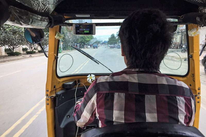 A tuk-tuk driver using PassApp Taxi navigates Phnom Penh on Monday. (Ear Uy)