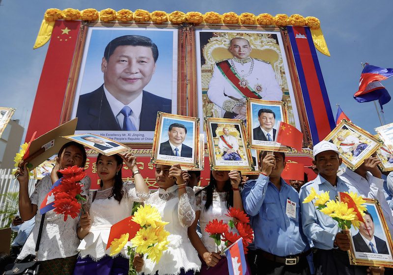 Crowds await Chinese President Xi Jinping’s motorcade on Thursday in Phnom Penh. (Pring Samrang/Reuters)