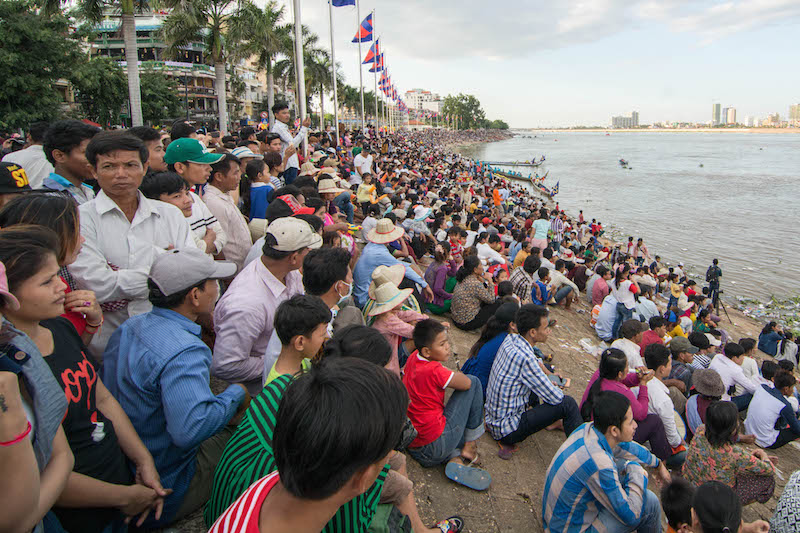 People gather on the bank of the Tonle Sap to watch Water Festival boat races in Phnom Penh on Sunday afternoon. (Alex Consiglio)