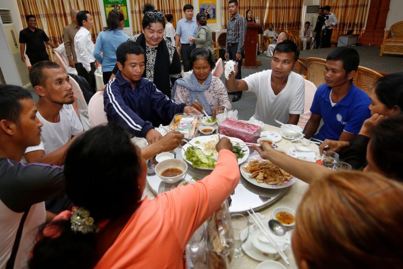 Former hostages of Somali pirates and their relatives share a meal in Phnom Penh on Tuesday. (Siv Channa/The Cambodia Daily)