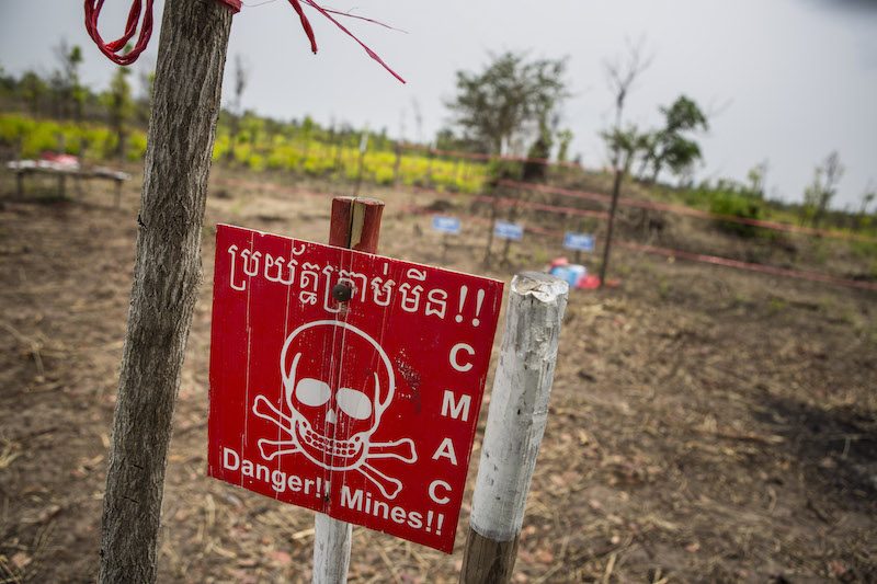 A danger sign marks a minefield that was being cleared by the Cambodian Mine Action Center in Battambang province in April. (Enric Catala)
