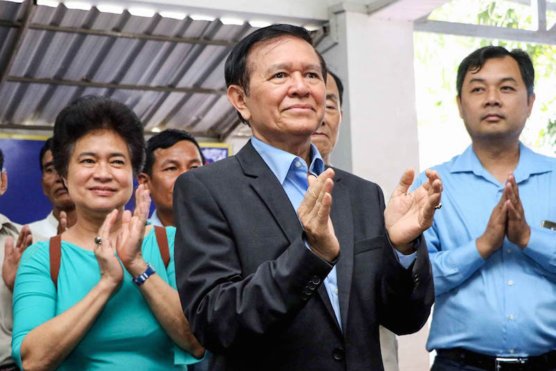 Deputy opposition leader Kem Sokha, center, claps along with senior lawmaker Tioulong Saumura, left, during a gathering with youth activists at the CNRP’s Phnom Penh headquarters on Sunday, in a photograph posted to Mr. Sokha’s Facebook page.
