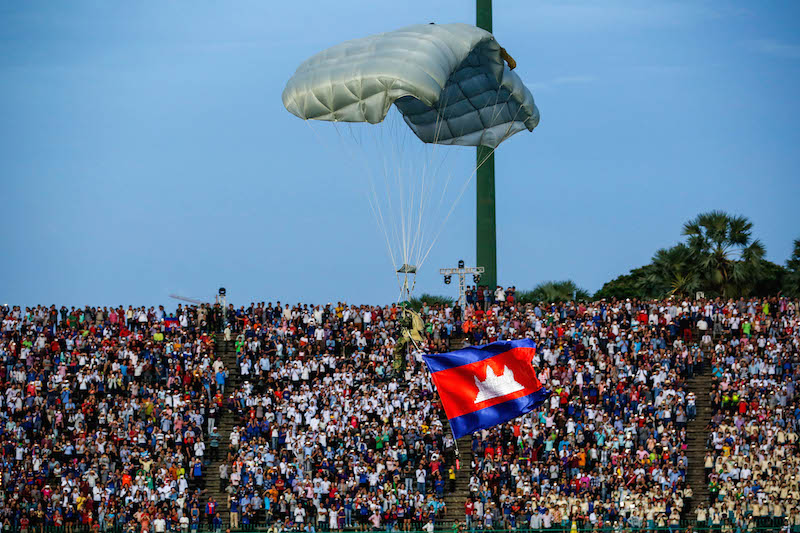 A paratrooper drops into Olympic Stadium during the opening ceremony of the National Games on October 28 in Phnom Penh. (Siv Channa/The Cambodia Daily)