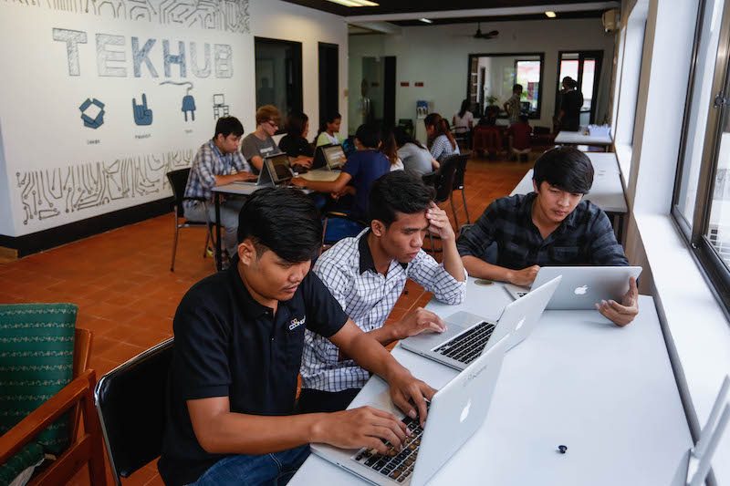 People work on their laptops in TekHub's new workspace in Phnom Penh on Thursday. (Siv Channa/The Cambodia Daily)