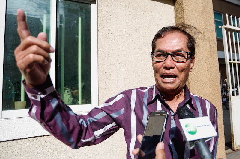 Chhun Bun San, the husband of Senator Thak Lany, speaks with reporters outside the Phnom Penh Municipal Court on Thursday. (Siv Channa/The Cambodia Daily)