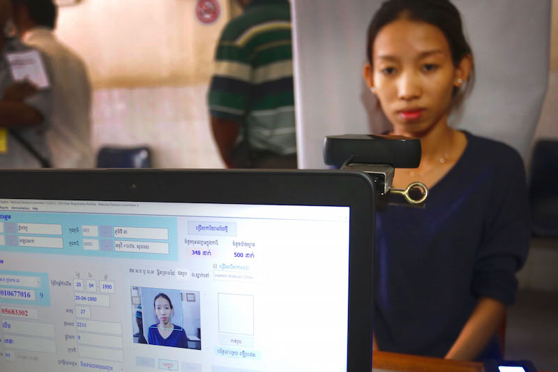 A woman is photographed while registering to vote at the Tonle Bassac commune office in Phnom Penh’s Chamkar Mon district on Tuesday. (Siv Channa/The Cambodia Daily)