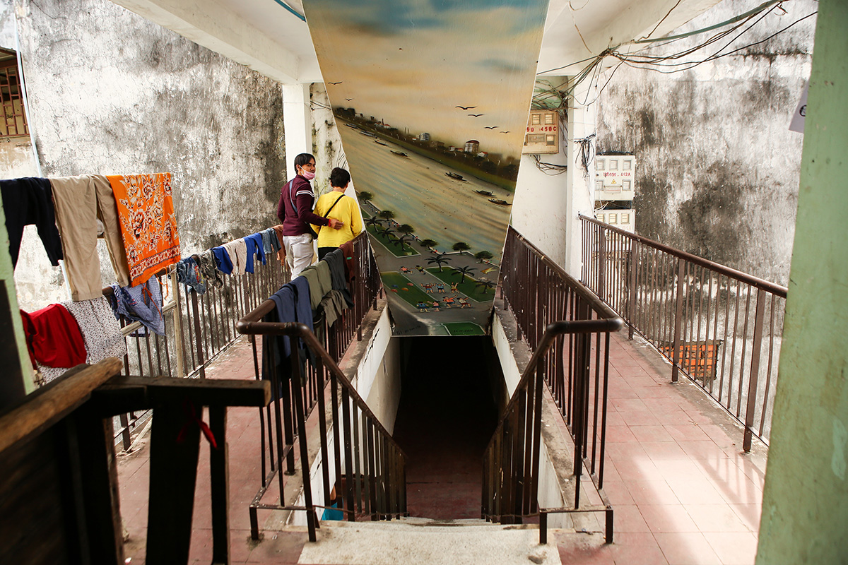 A mural is seen on the underside of one of the White Building’s outdoor stairwells. (Hannah Hawkins/The Cambodia Daily)