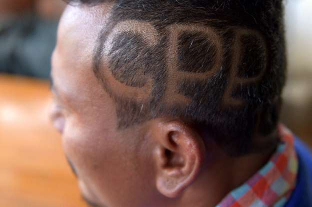 Haircuts and songs: Cambodia ruling party draws colourful support before poll