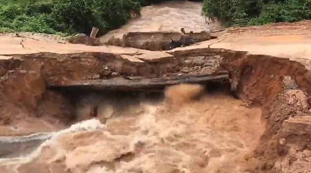 Terrifying moment motorcyclist and passenger plunge into flash flood after bridge collapses in Cambodia