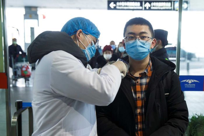 Coronavirus claims first life in China’s capital, as spread continues across the globe