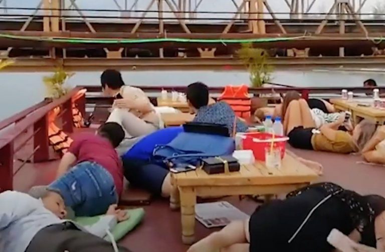 Diners on Cambodian river cruise duck to avoid colliding with low bridge (video)