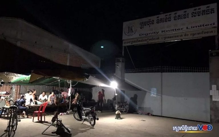 Awaiting Payouts, Fired Garment Workers Keep Watch Outside Factory