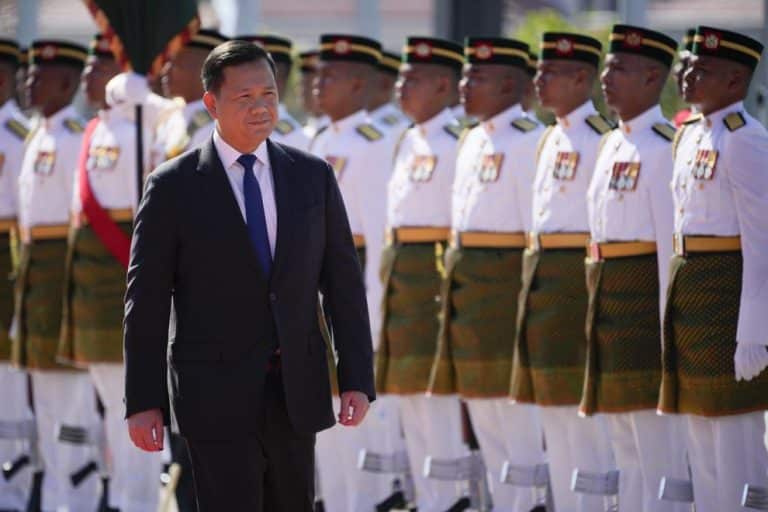 Cambodian Prime Minister Hun Manet inspects an honour guard during a visit to Malaysia on Tuesday. The prime minister’s family retain control of many senior roles in the Cambodian government. Credit: AP